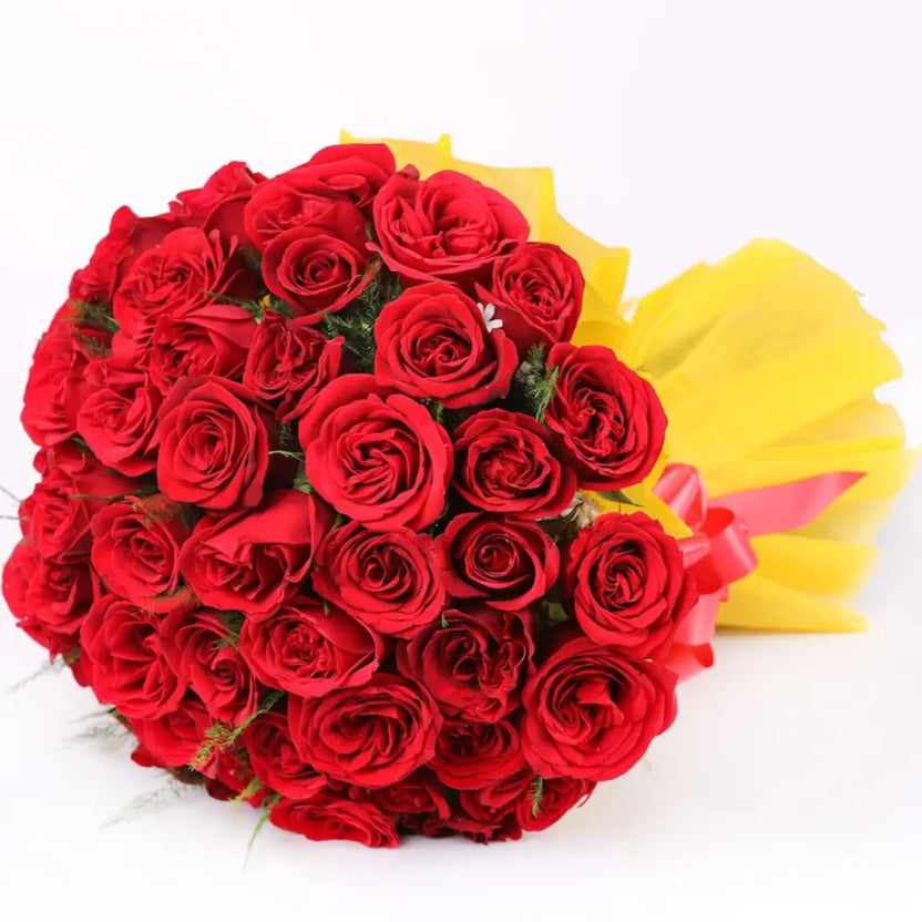 Passionate Bond Red Roses Bouquet featuring vibrant red roses wrapped in yellow paper, ideal for romantic gestures and anniversary celebrations. Main image