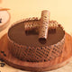 Chocolate cake with decorative elements on a wooden board
