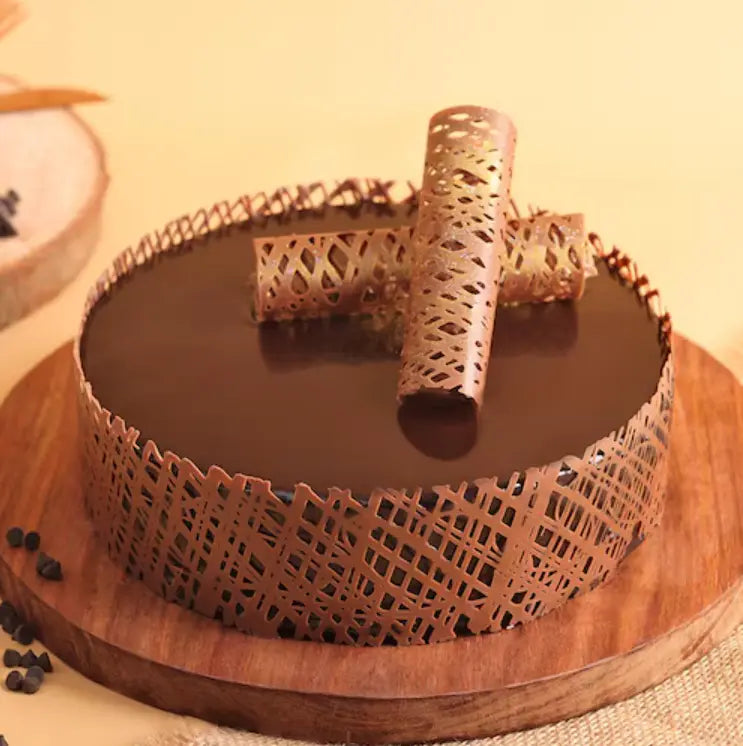 Chocolate cake with decorative elements on a wooden board Main image