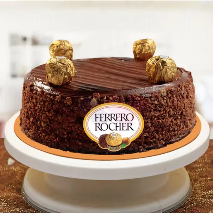 Chocolate cake with Ferrero Rocher chocolates on top, featuring the Ferrero Rocher logo. Main image