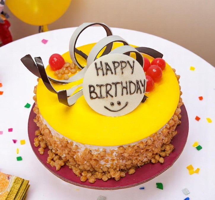 Birthday Butterscotch Cake - Perfect Celebration Treat with yellow glaze, chocolate swirls, cherries, and crispy caramel edges on a red base. Main image