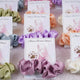 Multiple satin scrunchie card favors in pastel shades with custom bridal shower design, ideal for wedding and nikah celebrations.