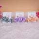 Set of three satin scrunchie bridal shower favors in grey, lavender, and peach with personalized cards, perfect for wedding gifts.