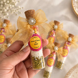 Customized Shahi Mix Sounf bottle for Nikah favours – glass vial with gold ribbon and personalized bride-groom name sticker