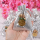 Handheld silver Nikah Favor Dry-Fruit Potli with custom tag, ideal for elegant Muslim wedding favors and celebration essentials.