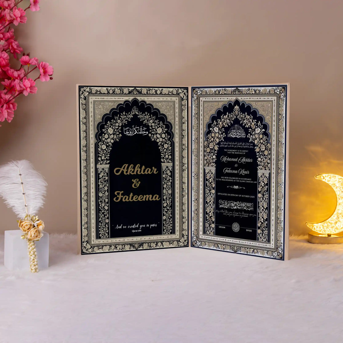 Elegant Siyah-e-Wafa Nikah Nama booklet opened to display intricate Islamic patterns and personalized wedding details in black and gold.
