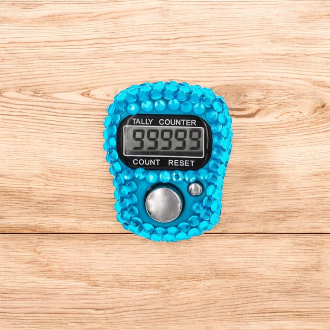 Close-up of turquoise digital tasbeeh counter with 99999 count. Modern zikr tool for spiritual connection.