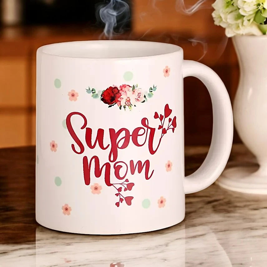 Super Mom Mug Gift with floral design and red text, perfect for Mother's Day. Personalized ceramic drinkware for home and kitchen use. Main image