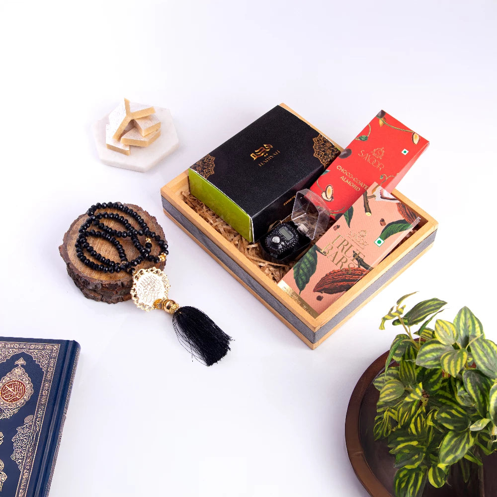 Elegant Khushi Aur Mithaas Ka Tohfa gift hamper featuring sweets, prayer beads, and luxury chocolates. Perfect for festive gifting and special occasions.