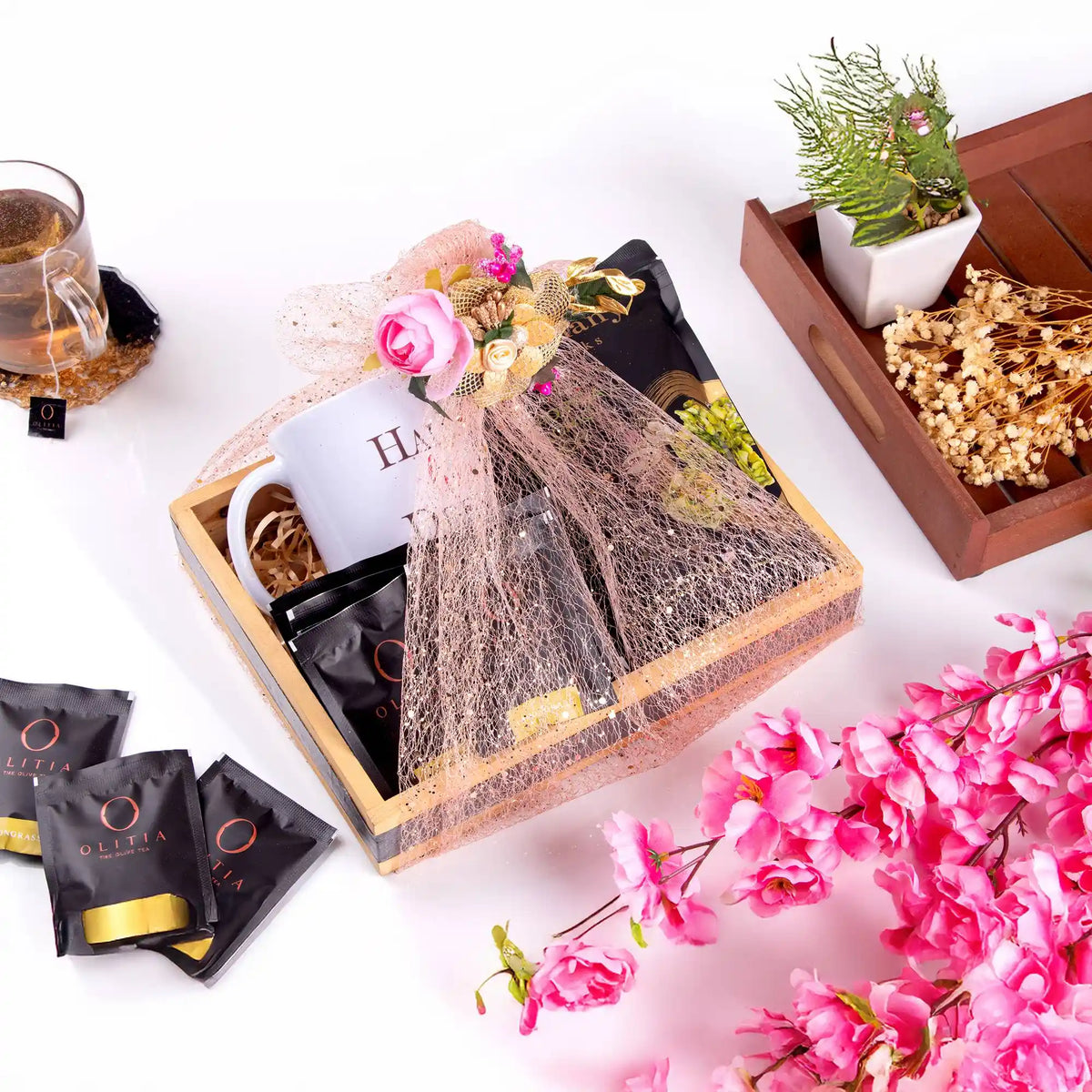 Gift set with tea bags, a white mug, and decorative elements on a white background.