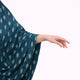 Extended arm view of teal cotton prayer dress with attached sleeves, highlighting lightweight fabric and modest ceremonial design.