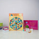 Board game set with colorful tiles and game pieces on a white surface.