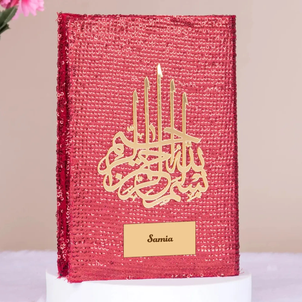 Urdu English Quran Gift in red sequin bling cover with gold Islamic calligraphy and personalized nameplate, ideal for weddings or Eid gifts. Main image