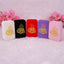 Five mini velvet Quran boxes lined up in a row in colors off-white, black, red, purple, and pink. Each box is decorated with gold Arabic calligraphy.
