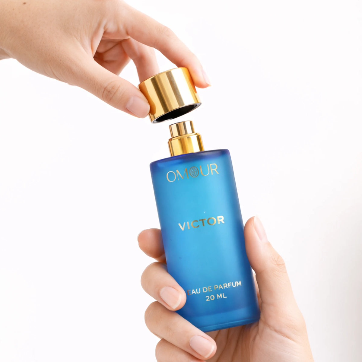 Blue perfume bottle with gold cap for Omour French Collection