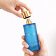 Blue perfume bottle with gold cap for Omour French Collection