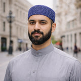 Man wearing blue prayer cap, traditional Islamic headwear for men