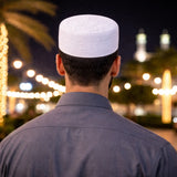 Man in traditional white prayer attire at Mecca