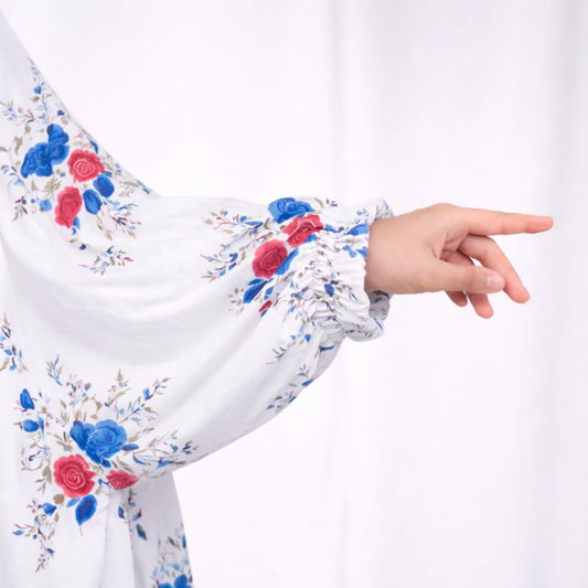 Close-up of Prayer Dress 10 sleeve with elastic cuff and vibrant floral print, showcasing lightweight fabric and elegant detailing.