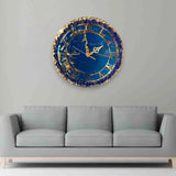 Eternal Blue Elegance Wall Clock with gold detailing and resin finish, displayed above a grey sofa in a modern living room setting.