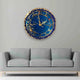Eternal Blue Elegance Wall Clock with gold detailing and resin finish, displayed above a grey sofa in a modern living room setting.