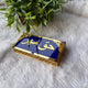 Side view of navy blue and gold Haqq Mehr envelope with ornate design, used for presenting Mehr in wedding ceremonies.