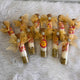 Multiple customized Shahi Mix Sounf Bottles arranged for Nikah favors, featuring festive gold ribbons and colorful sweet mix.