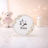 Kids Floral Pearl Name Frame with Stand featuring the name 'Azza' in Arabic and English, adorned with white roses and pearls, ideal for nursery decor.