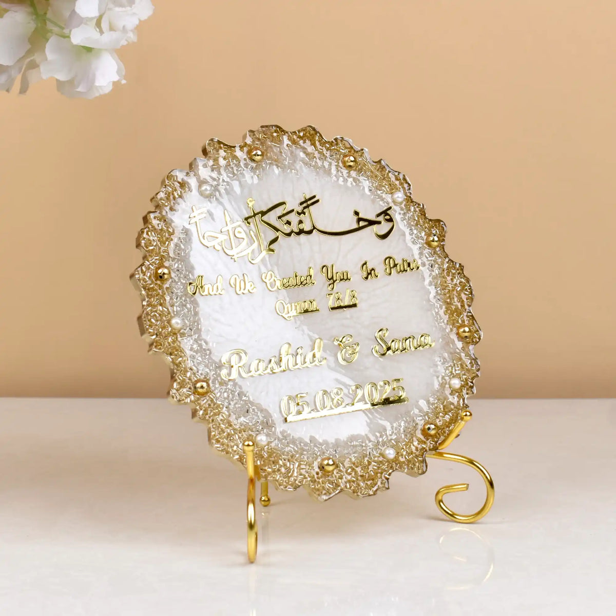 Decorative plaque with gold text on a beige background