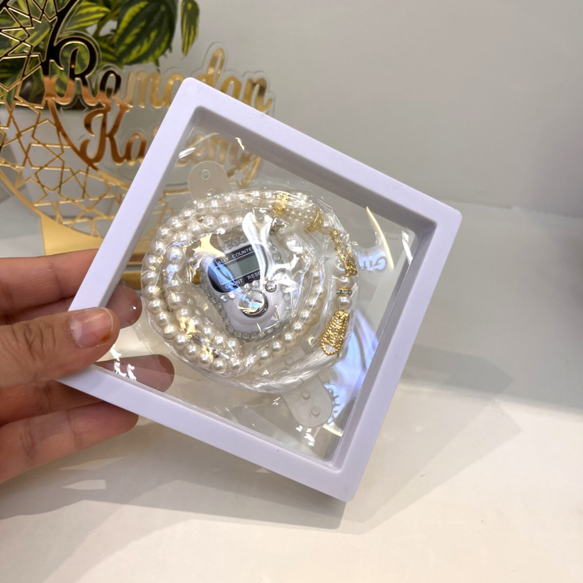 White Transparent Tasbeeh Combo with 100 prayer beads and digital counter in a display box, ideal for Ramadan and Eid spiritual gifting.