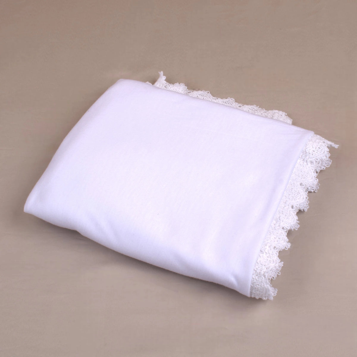Folded Ihram Women Hosiery - Hajj & Umrah Essentials Online made of soft white fabric with lace detailing, perfect for travel and gifting.