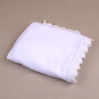 Folded Ihram Women Hosiery - Hajj & Umrah Essentials Online made of soft white fabric with lace detailing, perfect for travel and gifting.