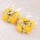 Two yellow flower crowns with ribbons on a light gray background