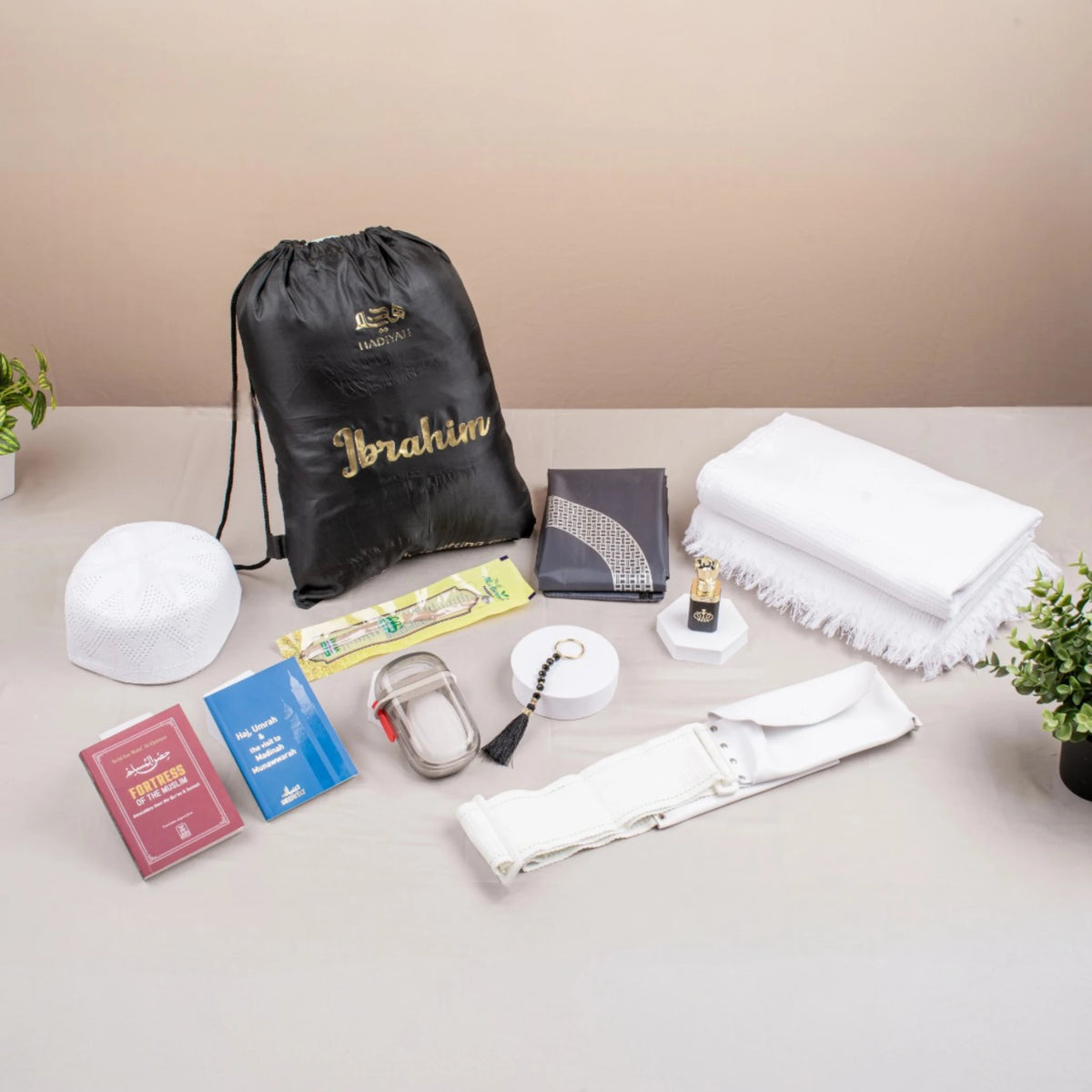 Zad-al-Hajj Men's Kit - Hajj Umrah Essentials featuring Ihram, tasbeeh, books, belt, cap, and travel pouch for a complete pilgrimage set.