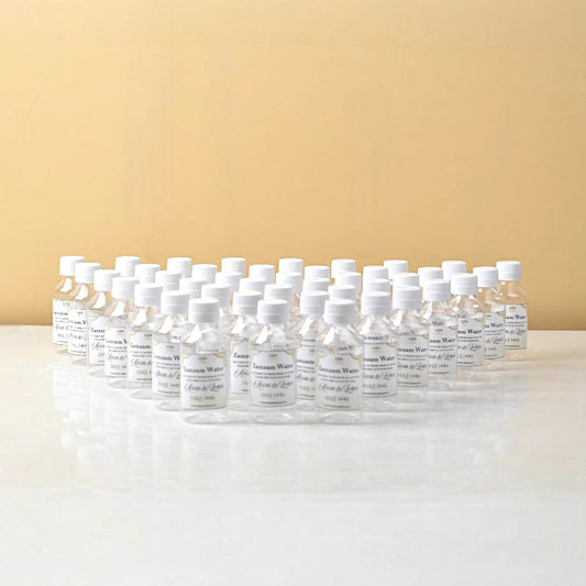 Set of 50 Blessed Drops Zamzam Bottles 100ml arranged in rows, perfect for Hajj & Umrah favors and sacred water gift sets from Makkah.