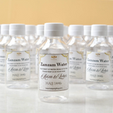 Zamzam Bottles 100ml Pack - Sacred Water Gifts featuring personalized Hajj 1446 labels, ideal for Umrah return gifts and Islamic celebrations.