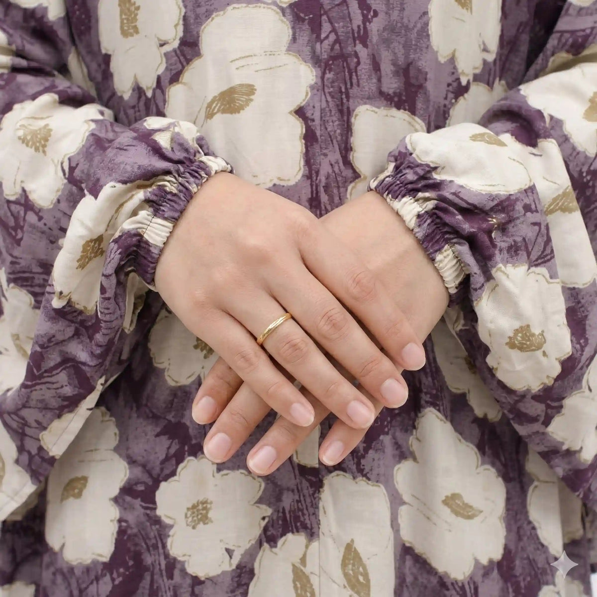 Woman in floral prayer dress with arm raised, showing sleeve detail