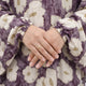Woman in floral prayer dress with arm raised, showing sleeve detail