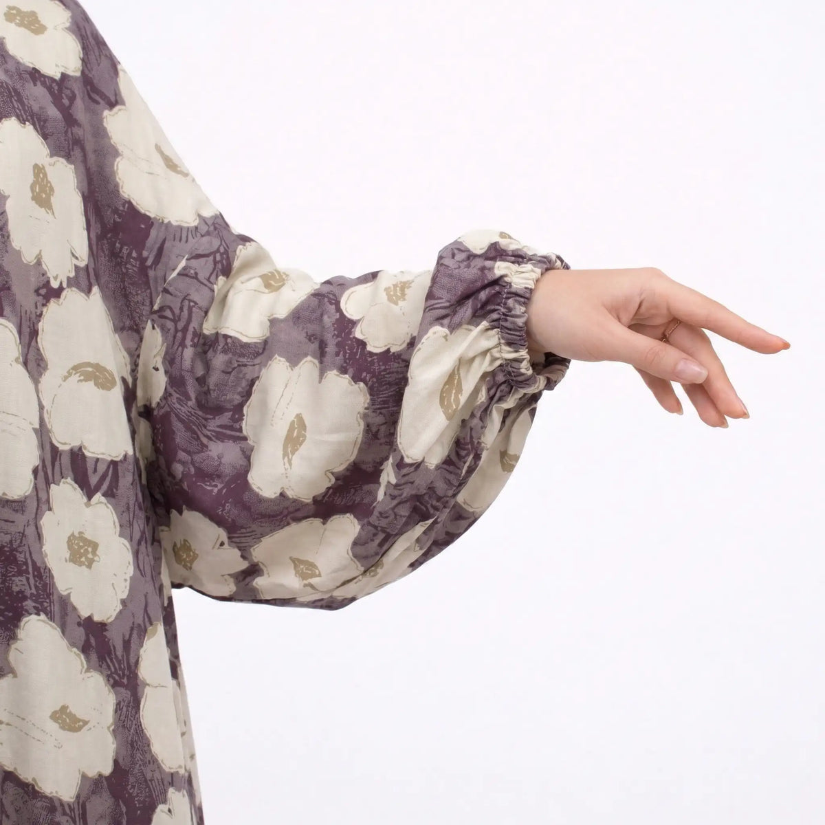Close-up of woman in floral prayer dress with hand on chest