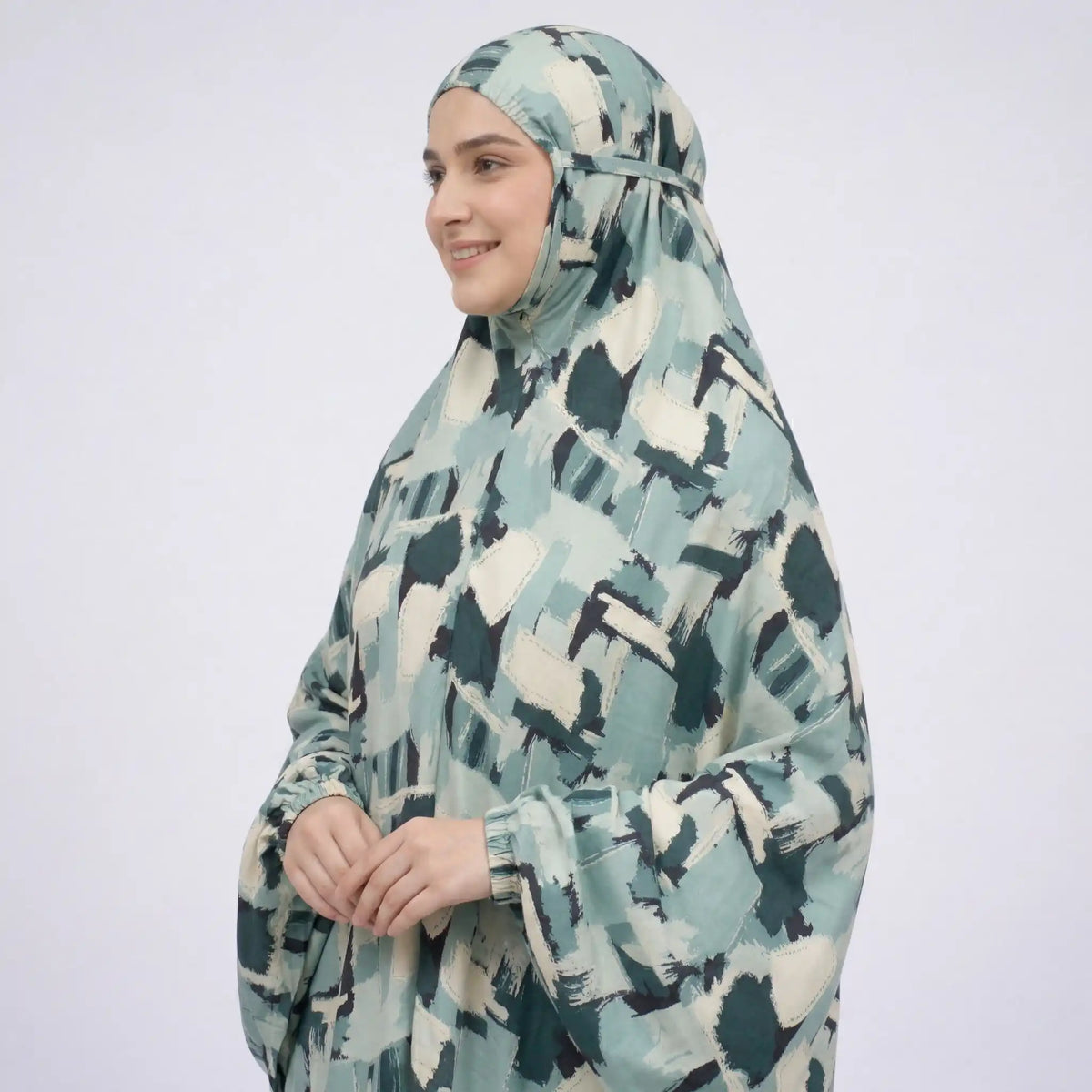 Side view of woman wearing lightweight printed cotton prayer dress with tied back