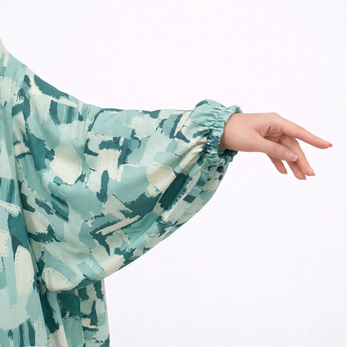 Woman's hand showing ring and sleeve of printed cotton prayer dress