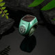 Green Smart Zikr Ring Flex Pro on black stones, featuring OLED display and tasbih counter for daily zikr.