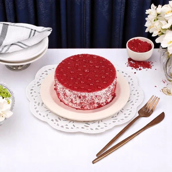 Classic Mini Red Velvet Cake - 300gm with creamy cheese frosting, displayed on a white lace plate, perfect for birthdays or anniversaries. Main image