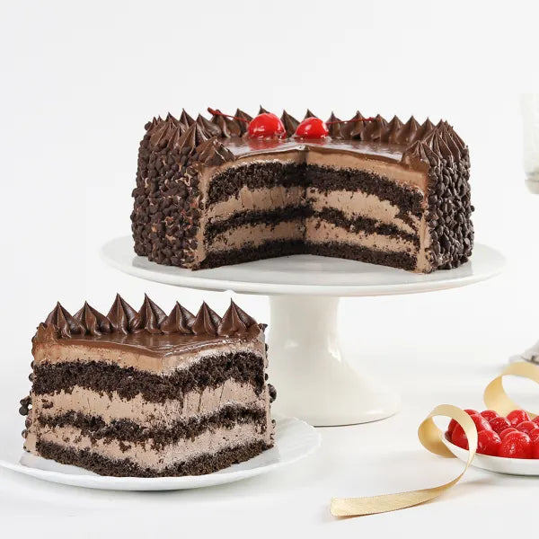 Layered Death By Chocolate Cake with fudge, ganache, and dark sponge, ideal for chocolate lovers and special occasions.