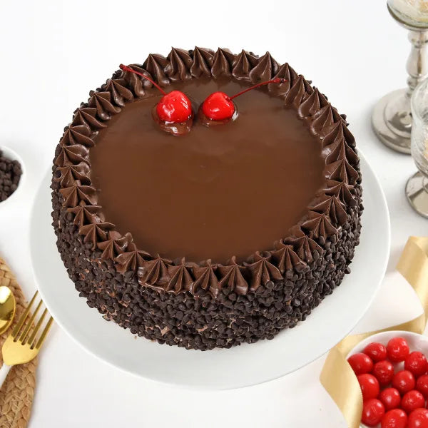 Round Death By Chocolate Cake with glossy ganache top, cherry garnish, and chocolate chip sides, great for gifting and celebrations.