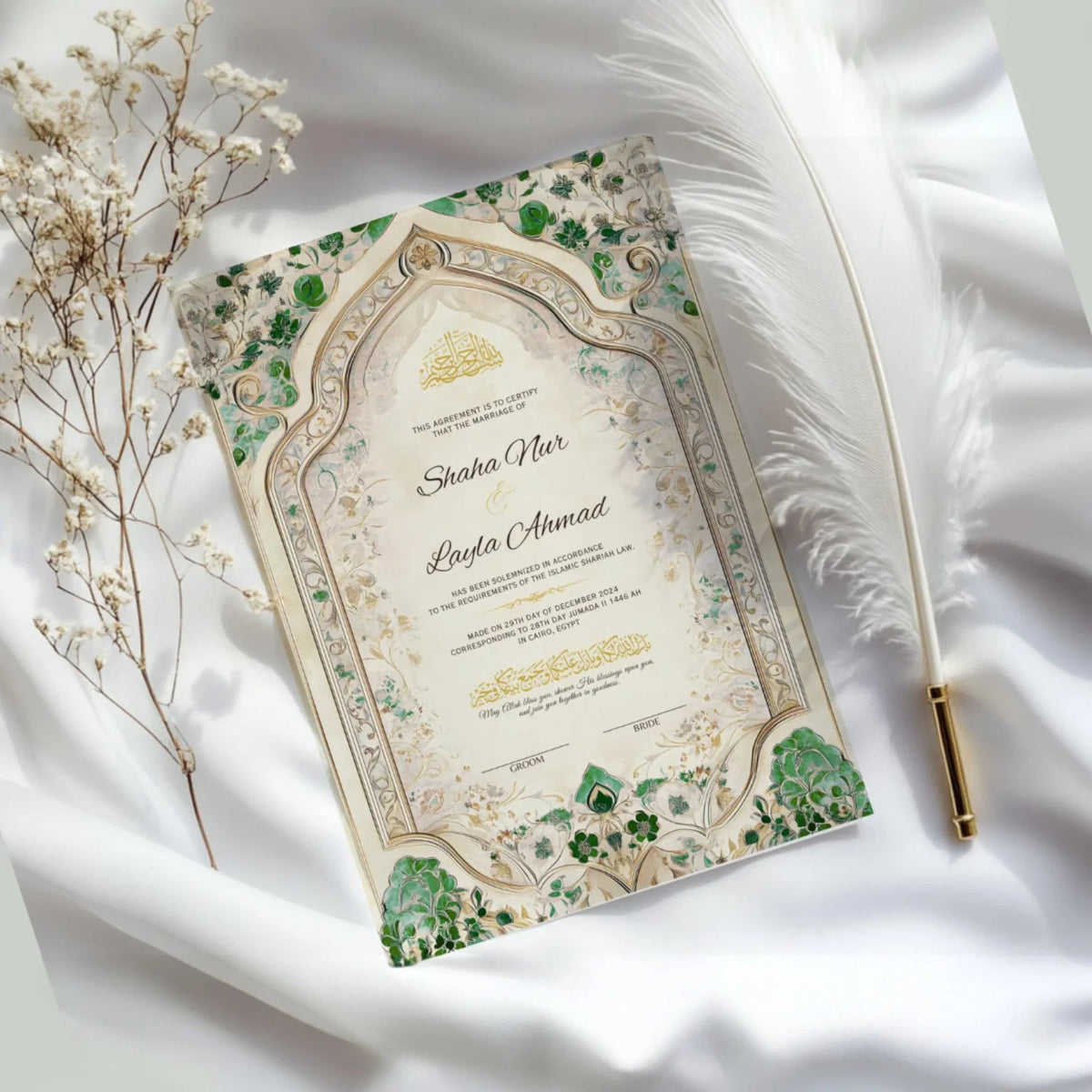 Flat lay of Emerald Nikah Nama Frame on white satin with feather and dried flowers, showcasing elegant Islamic wedding keepsake.