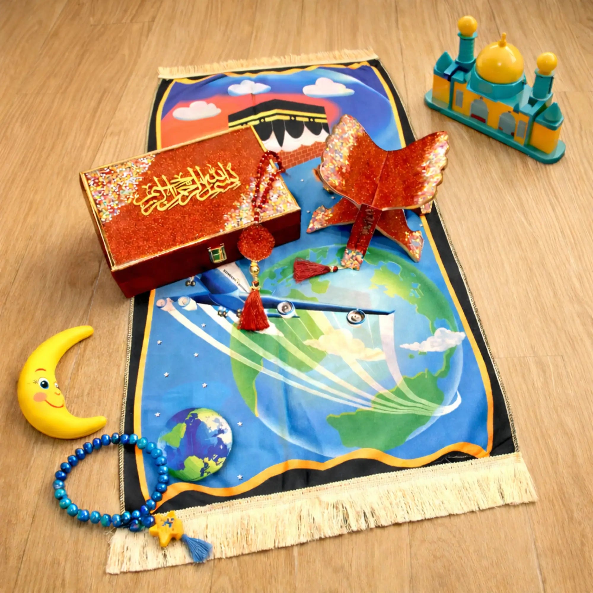 Kids Sawab-e-Jariya Hamper in red with prayer mat, glitter Quran stand, tasbeeh, and Islamic toys. Ideal Islamic gift set for children.
