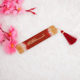 Acrylic maroon and gold bookmark with tassel from the Maroon Sequence Rehal Hamper - Luxury Quran Gift Set. Stylish Islamic reading accessory.