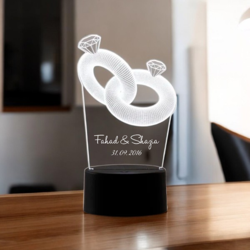 Couple Ring LED Lamp with personalized names and date on black base, featuring intertwined rings with diamond tops. Ideal wedding or anniversary gift. Main image