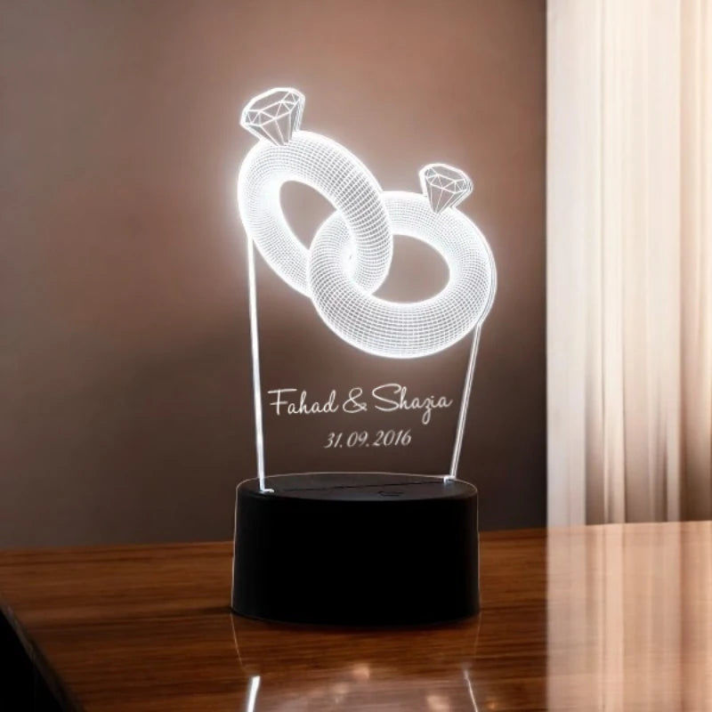 Decorative lamp with interlocking rings design on a wooden surface.